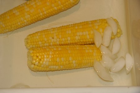 Ears of corn cooling in ice bath