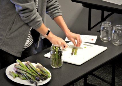Preparing fresh asparagus pieces for canning photo