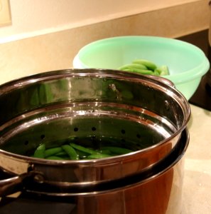 Blanching pot with peas photo