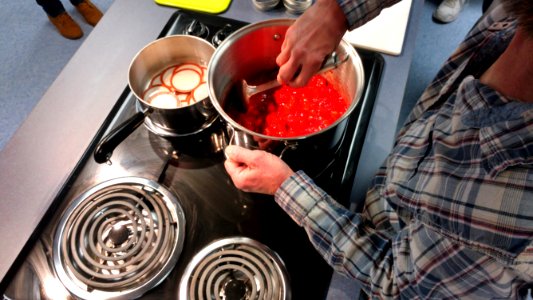 Stirring cooked strawberries photo