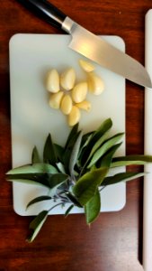Fresh sage and garlic on cutting board photo