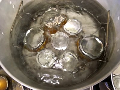 Processing jam jars in boiling water bath canner photo