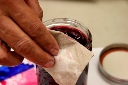 Using paper towel to wipe jar rim photo