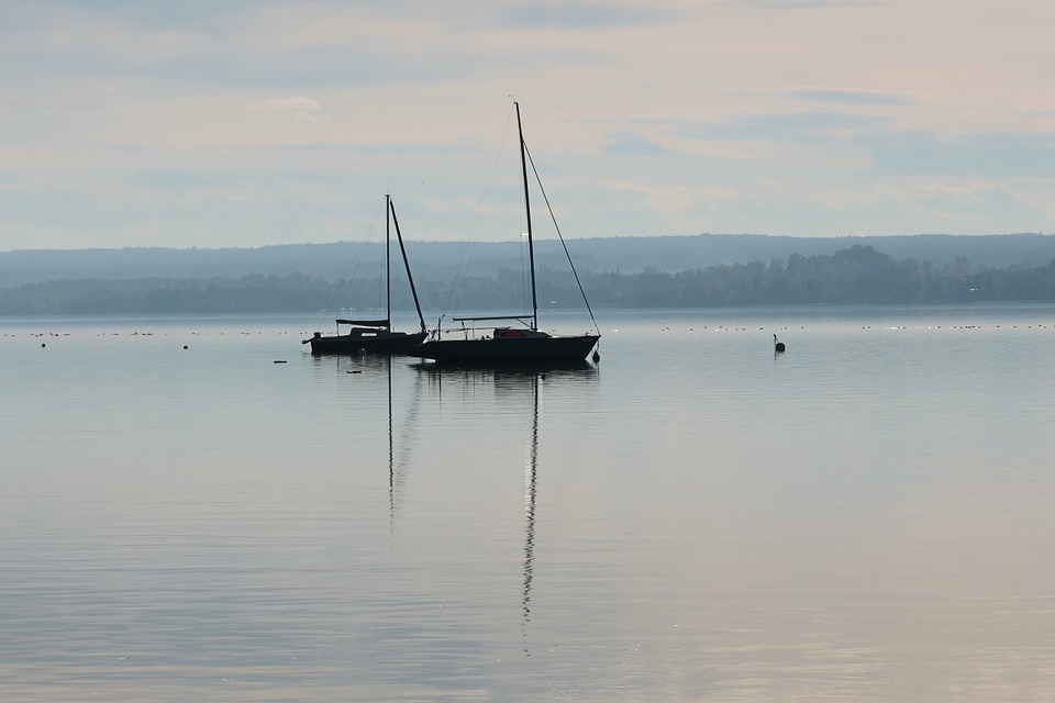 Lake sailing boat mirroring