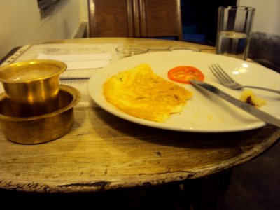 Midway through cheese omlette and filter coffee at Alcha, Shantiniketan
