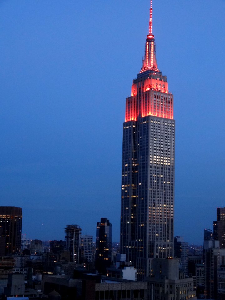 New York. The Empire State lights at dusk from wedding reception venue.
