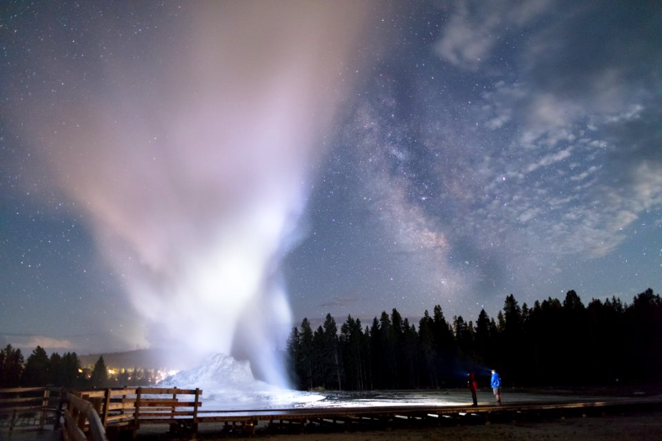 Father and son watch a Castle Geyser night eruption