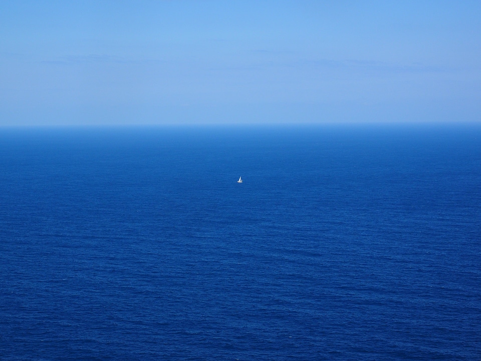 Blue water sailing boat photo