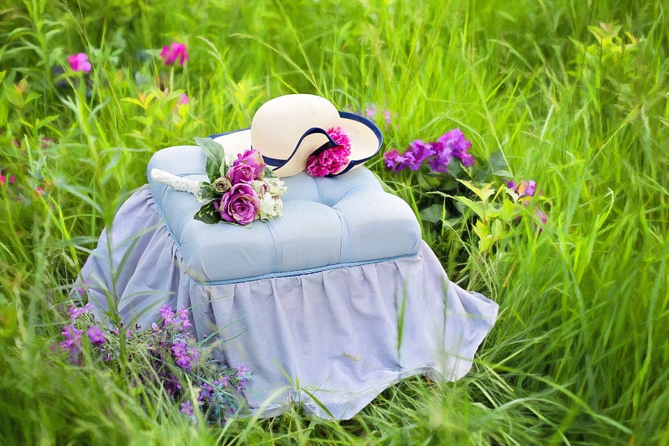 Hat on a bench flowers meadow