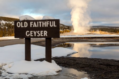 Old Faithful eruption and sign photo