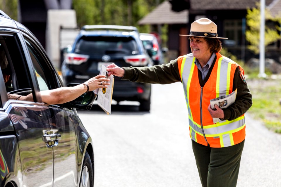 Ranger welcomes people at West Entrance photo