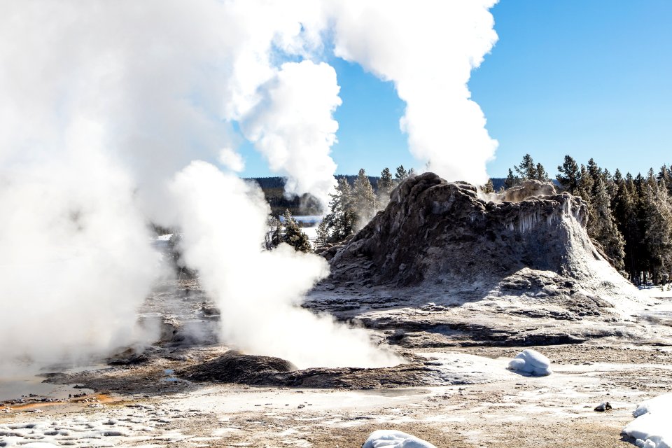 Castle Geyser steaming with Old Faithful in the background