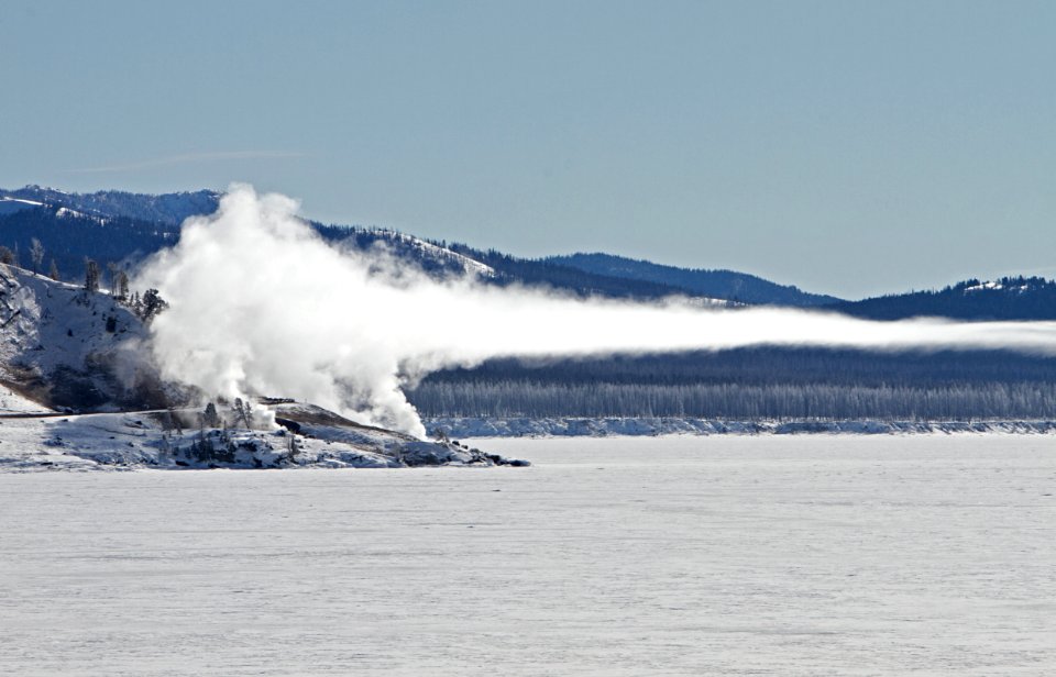 Steam from Steamboat Point drifts over frozen Yellowstone Lake
