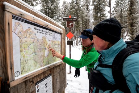 Skiers read a topo map at the start of Snow Pass Trail photo