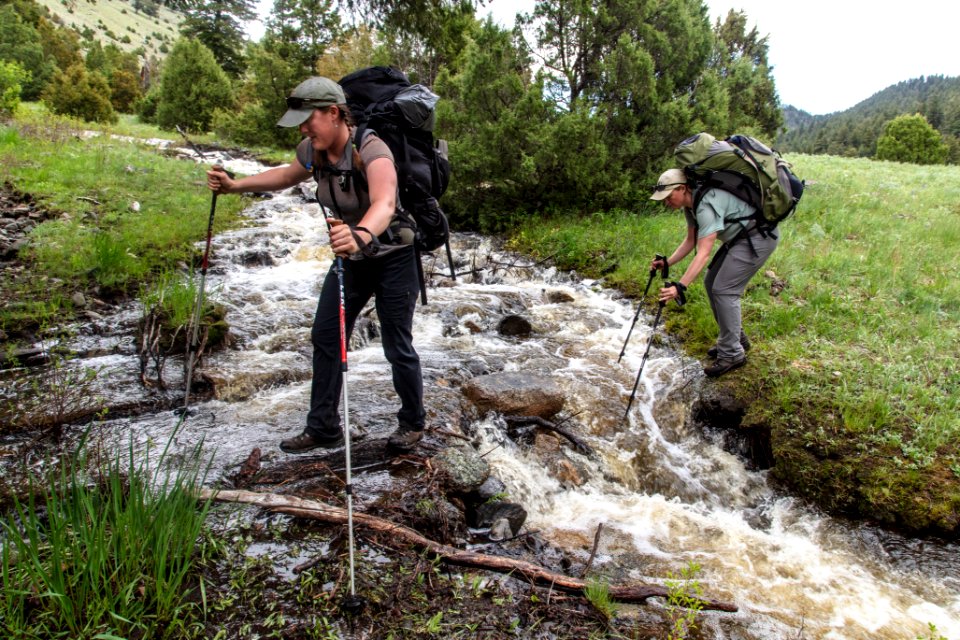 Backpackers cross an unnamed stream near Little Cottonwood Creek