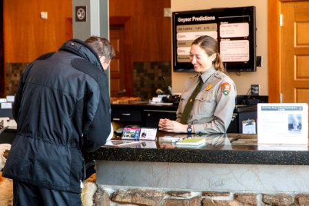 Ranger speaks with a visitor at Old Faithful Visitor Education Center