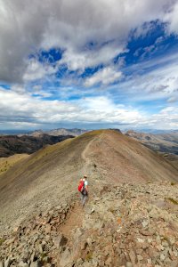 Hiker exploring the ridge of Avalanche Peak (portrait)