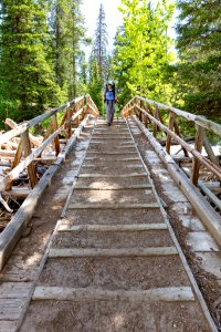 Backpacker crosses the Horse Creek Bridge in the Absaroka Beartooth Wilderness (portrait)
