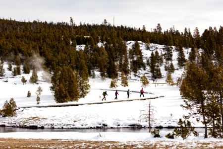 Skiers on the boardwalks in Upper Geyser Basin