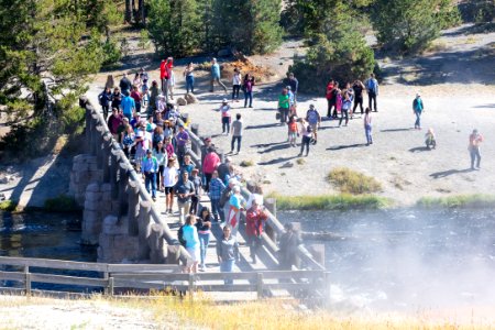 People on the Firehole River bridge at Midway Geyser Basin