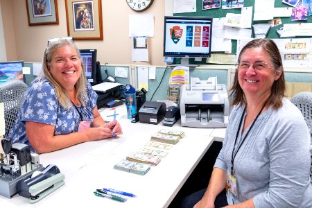 Tellers, Pat Moran and Cheryl Gallagher, counting fees in the Central Fee Office