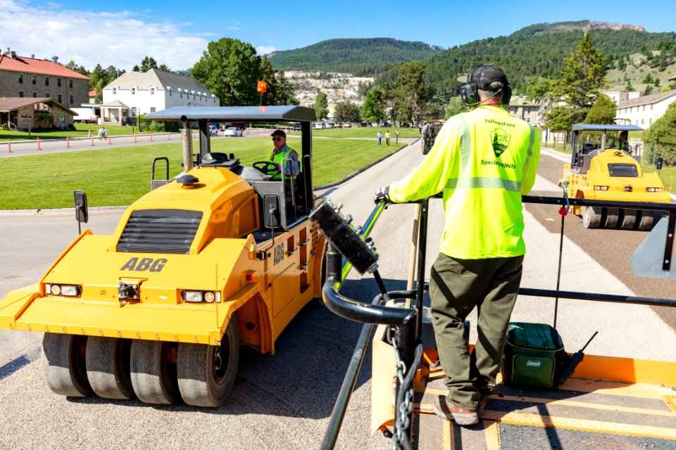 Pneumatic tire roller pressing the gravel into the asphalt
