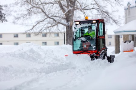 Employee clearing the sidewalks after a snowstorm (2) photo
