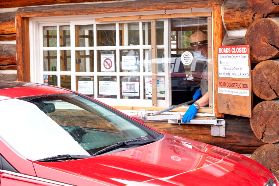 Park employee welcomes visitors at the South Entrance on Opening day 2020