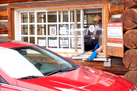 Park employee welcomes visitors at the South Entrance on Opening day 2020 photo