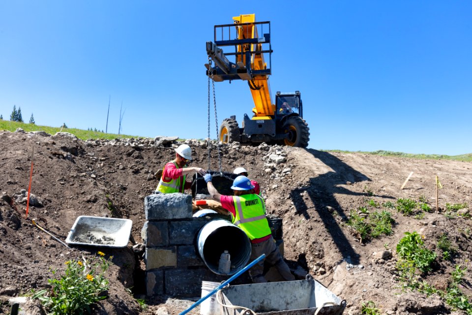 Tower to Chittenden Road Project: setting a basalt stone on a headwall