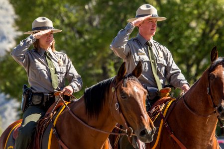 Jackie Sene and Dan Kowalski, members of Yellowstone's Color Guard, salute the flag.