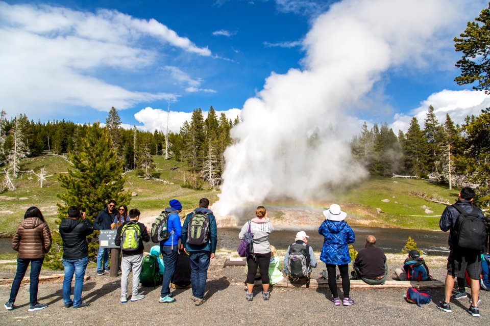 A crowd gathers to watch an eruption of Riverside Geyser