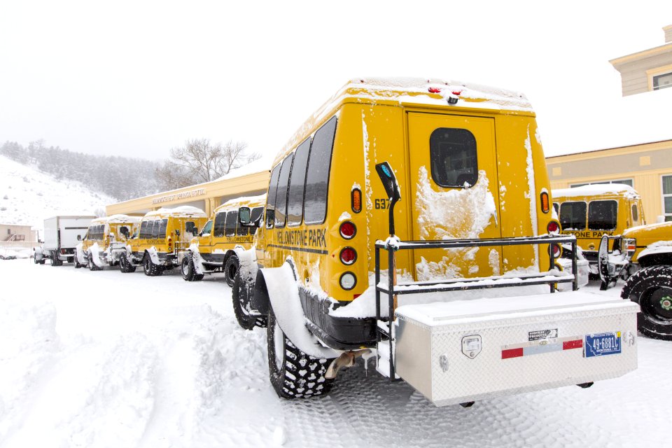 Snowcoaches outside the Mammoth Hot Springs Hotel