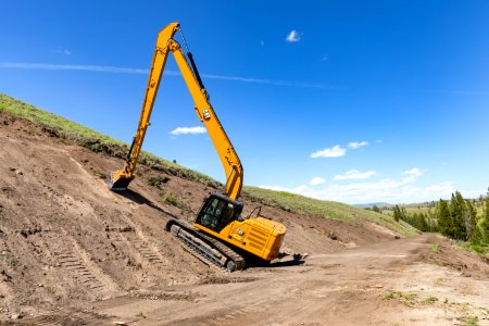 Tower to Chittenden Road Project: a long-boom excavator removes top soil in preparation to widen the road