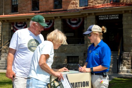 SCA Emily gives a park orientation outside the Albright Visitor Center