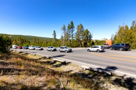 Vehicles wait on the main road in all directions for a spot in Midway Geyser parking area