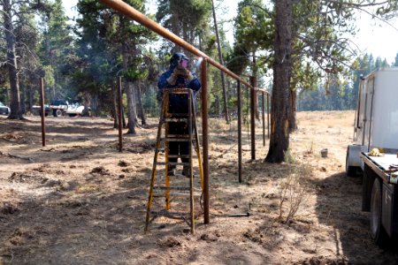 Canyon Corral volunteer project: tacking posts into place