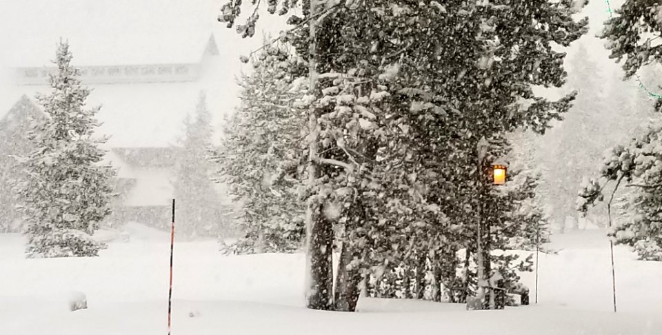 Old Faithful Visitor Center in snowstorm photo