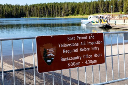 Boat permit and Yellowstone AIS inspection sign at Bridge Bay Marina