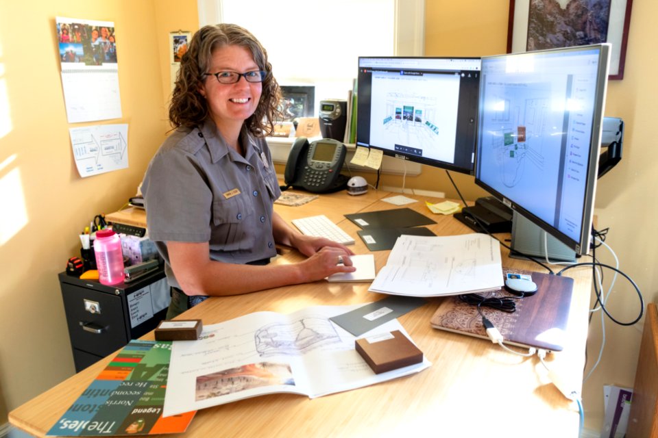 Exhibits Specialist, Bianca Klein, looks over exhibit plans for Norris Geyser Basin Museum