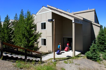 Grant Village, visitors moving luggage into a building