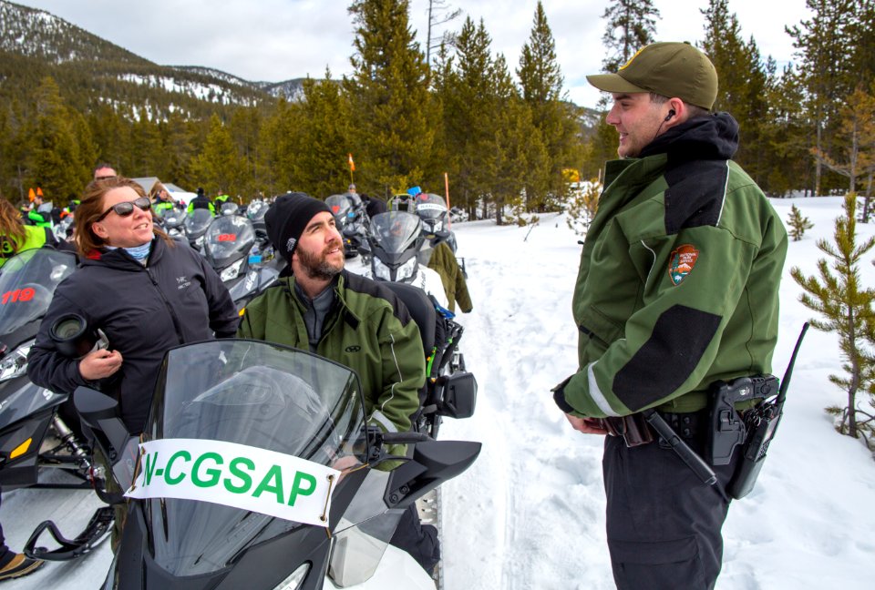 N-CGSAP riders talking with a ranger at the Madison Warming Hut