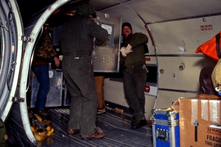 Unloading wolves in shipping containers from U.S. Forest Service plane at Bozeman Airport