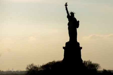 statue of liberty sillhouette at sunset photo