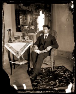Young man in a wicker chair, c1913 photo