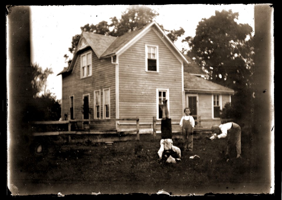 Boys playing in front of a house, c1913