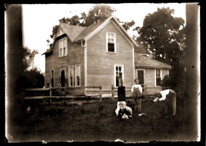 Boys playing in front of a house, c1913 photo
