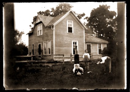 Boys playing in front of a house, c1913