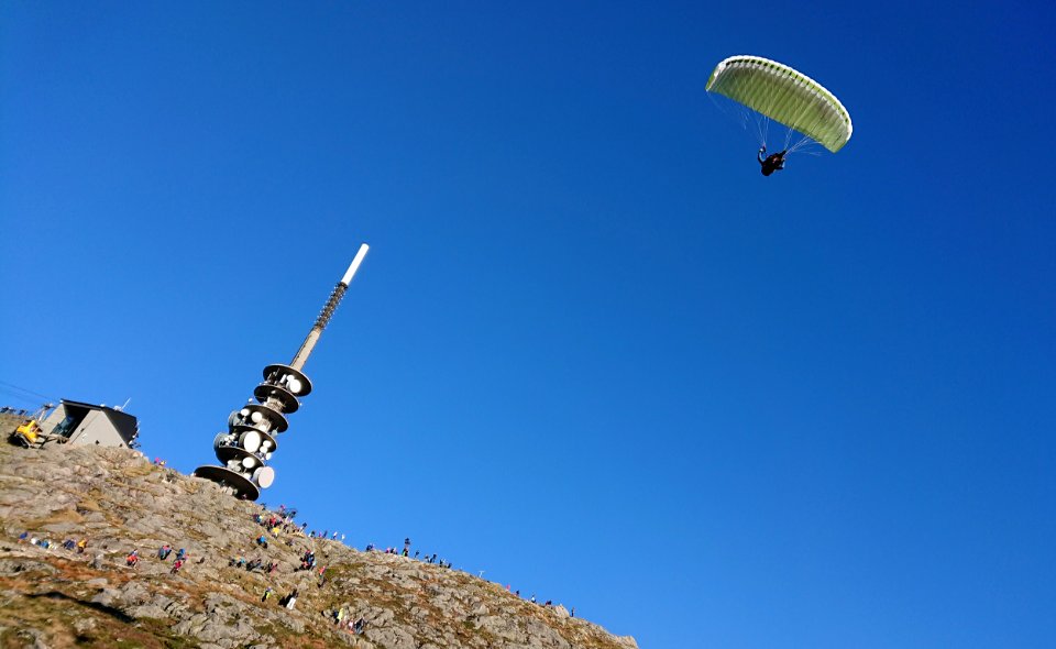 Paraglider over Ulriken radio mast, Bergen, Norway