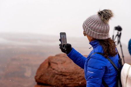 tourist taking photo of her husband photo